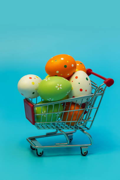 Easter eggs in the Shopping cart on blue background