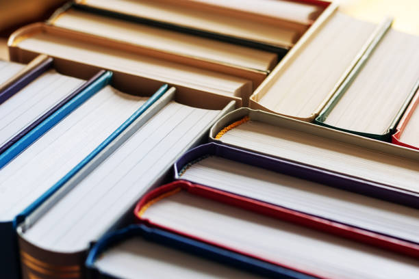 istock Background of hardbound books arranged in stacks in bookstore, selective focus 1209683438