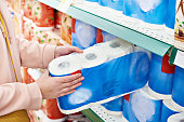 Toilet paper in hands of buyer at store
