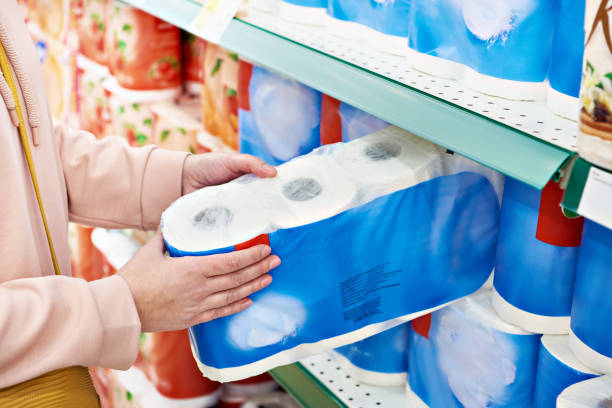 Toilet paper in hands of buyer at store Toilet paper in the hands of the buyer in the store toilet paper photos stock pictures, royalty-free photos & images