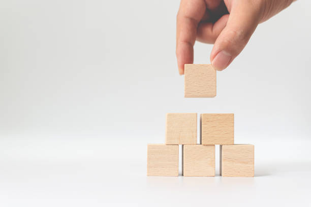istock Hand arranging wood block stacking on top with white background. Business concept for growth success process 1209687198
