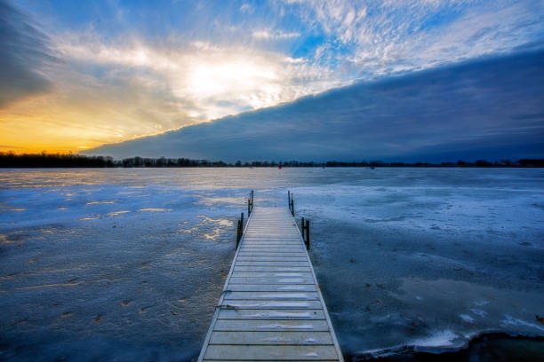 istock Pier at Sunset at Frozen Lake 1209687302