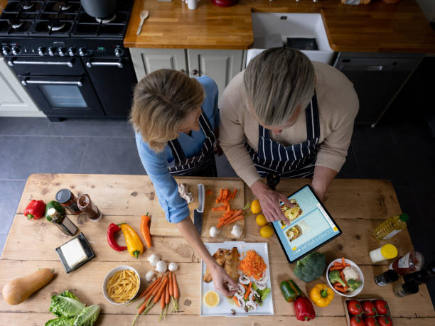 istock Couple cooking at home following a recipe on a tablet computer 1209687510