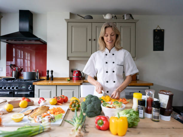 istock Professional chef working at a house and cooking dinner 1209687517