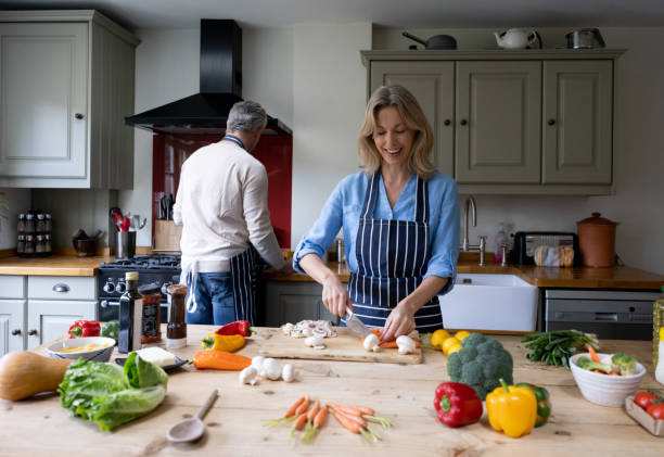 istock Happy couple cooking together at home 1209687533