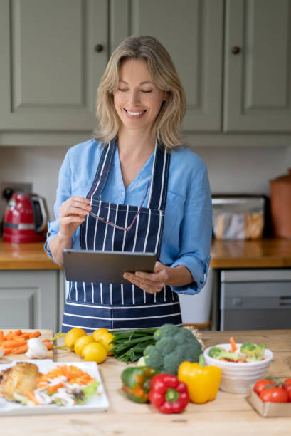 istock Happy woman taking cooking lessons online 1209687539
