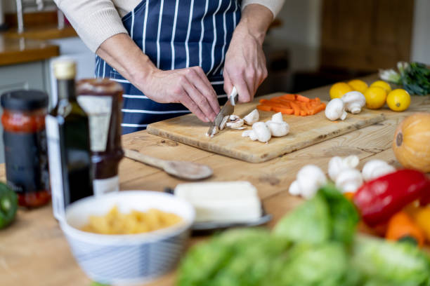 istock Close-up on a man cooking at home and chopping vegetables 1209687542