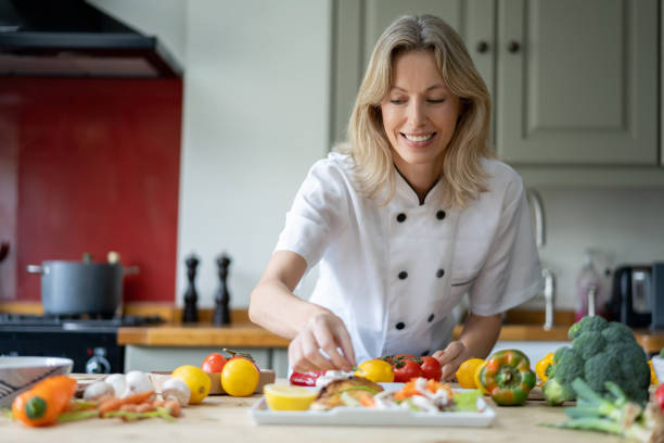istock Personal chef in the kitchen cooking a healthy meal at home 1209687574