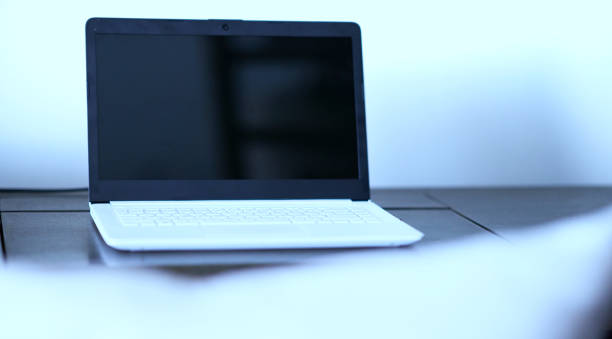 istock white laptop on table with blur foreground with mock up copy space 1209689383