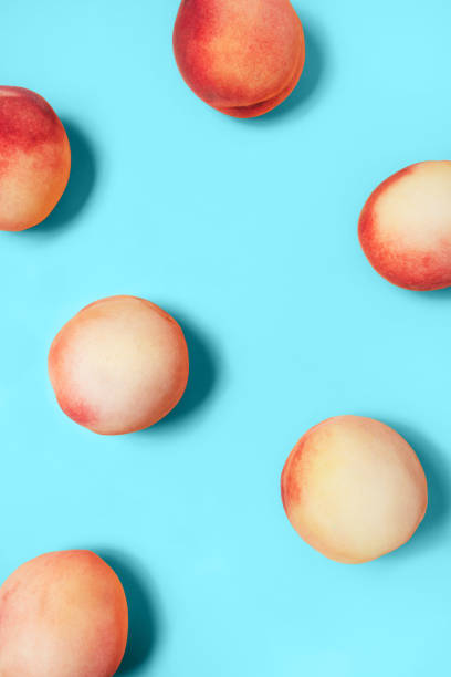 istock A few peaches on a turquoise background. 1209692525