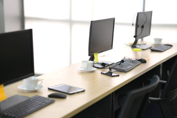 istock Chairs computers and headset call center in modern office 1209692593