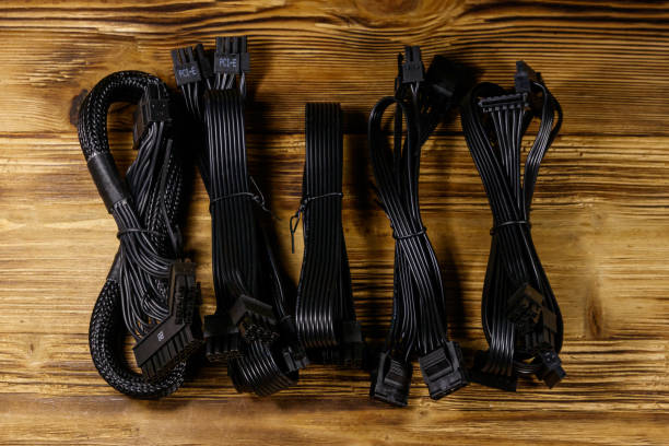 istock Set of cables for computer PSU on a wooden desk 1209693337