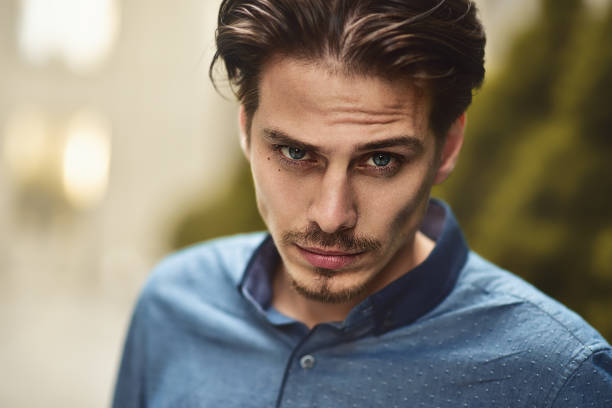 Portrait of stylish guy looking at camera.