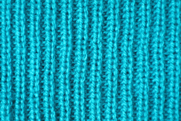 istock Closeup Texture of Turquoise Blue Alpaca Knitted Wool Fabric in Vertical Patterns 1209694086