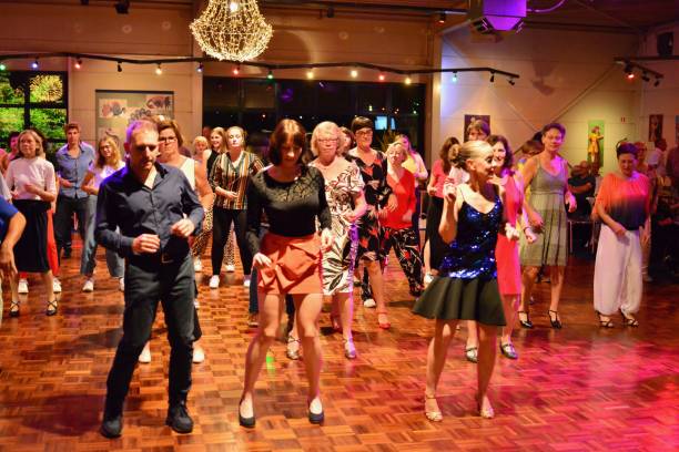 Workshop classes. Indoor line dancing by a professional instructor. Herent, Belgium - September 14, 2019: Open House indoor dancing classes evening show. Photo reportage open door promotion indoor dance classes. Courses starting half September. Teacher in front of group demonstrates solo dance. teacher retirement party stock pictures, royalty-free photos & images