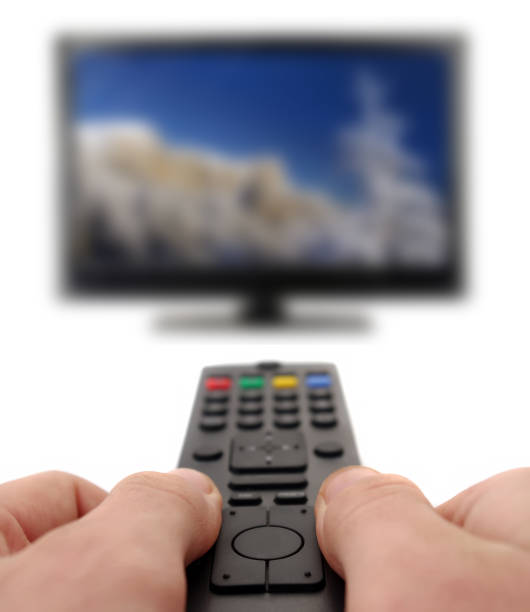istock hands with remote for tv with mountain landscape 1209694267