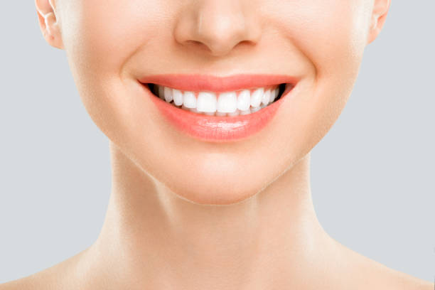 istock closeup of smile with white healthy teeth 1209695811
