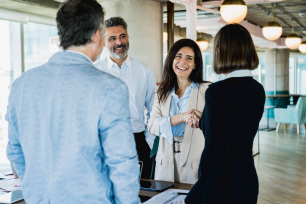 istock Female corporate executives shaking hands in agreement 1209698714