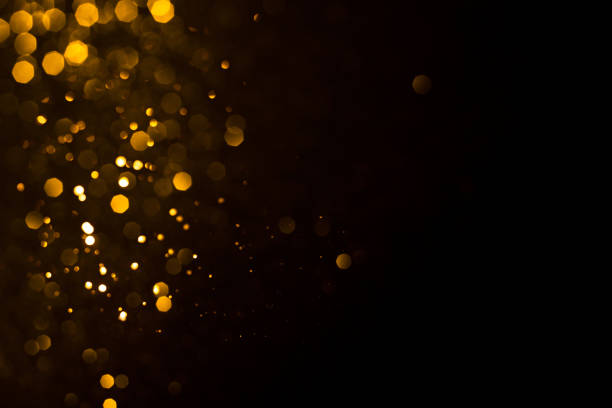istock Golden abstract bokeh on black background. 1209698720