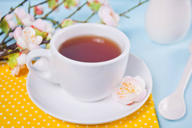 istock A cup of tea and cherry blooming with flowers sakura on the table. Spring concept. 1209698867