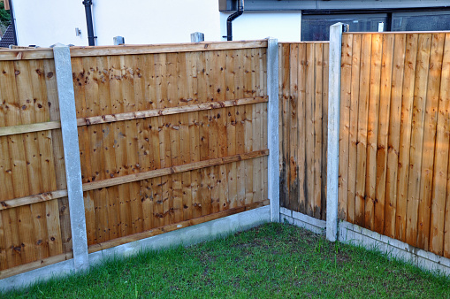 New garden fence made with five by six shiplap panels in between concrete posts. New build houes. Billericay, Essex, United Kingdom, February 20, 2020