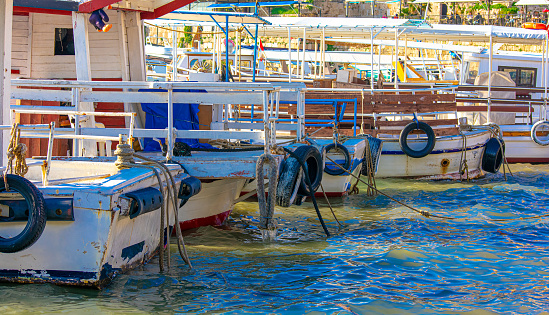 A row of tourist boats anchored in the harbor of the Lebanese town Byblos