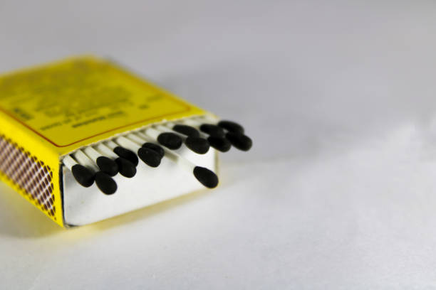 istock A creative concept of a wax match box with with stick and black head 1209700353