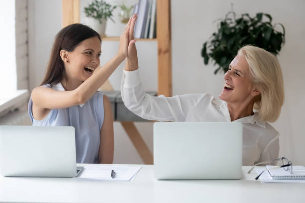 istock Different generations women colleagues giving high five celebrating common success 1209703845