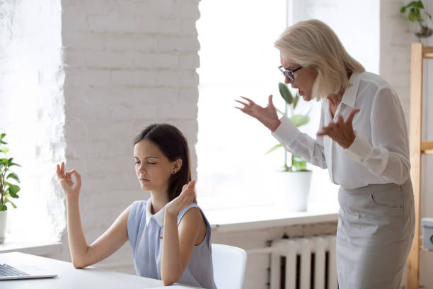 istock While boss screaming employee meditating seated at workplace desk 1209703853