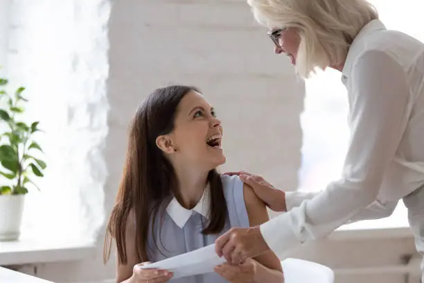 Photo of Grateful boss giving monetary reward to employee for great work