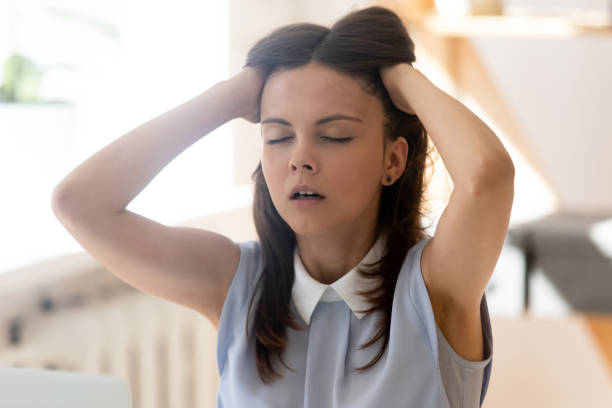 overstrained student after university exam feels relief resting seated indoors - overstrained imagens e fotografias de stock