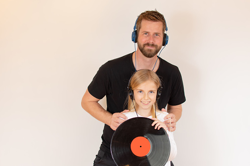 Father And Daughter Listening To Music Stock Photo - Download Image Now