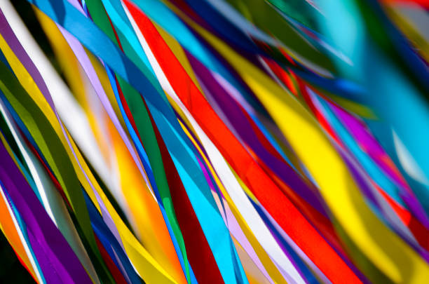 istock Many multicolored ribbons flutter in the wind in the sun. background 1209709336