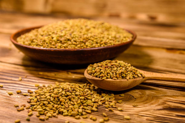 istock Ceramic plate and spoon with fenugreek seeds on wooden table 1209709577