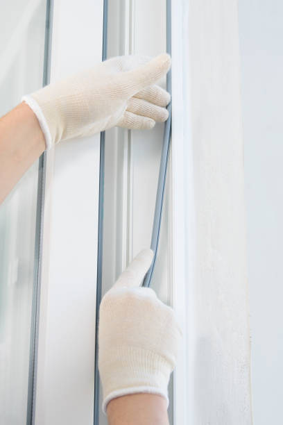 istock a gloved craftsman lays a rubber seal when installing a new plastic window, close-up 1209709700