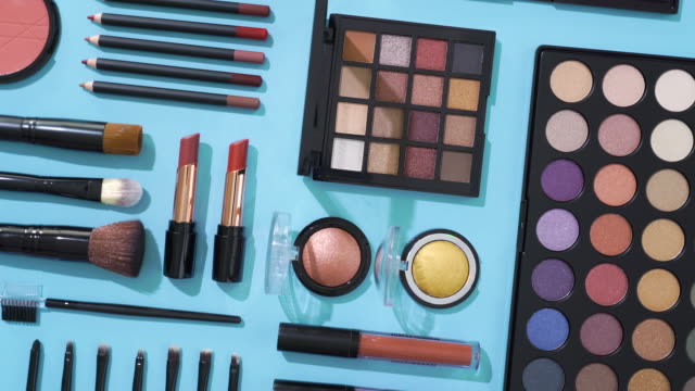 Rotation of cosmetic and make up brush collection on blue background