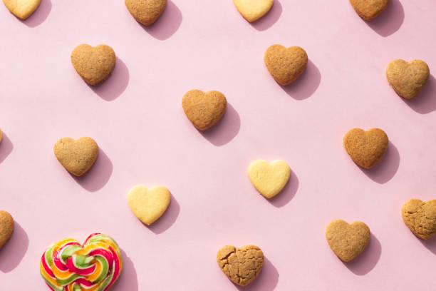 istock Flat lay composition with heart shaped cookies on pink paper background. Cookies pattern, minimal composition. Love concept. Romantic congratulation. 1209713238