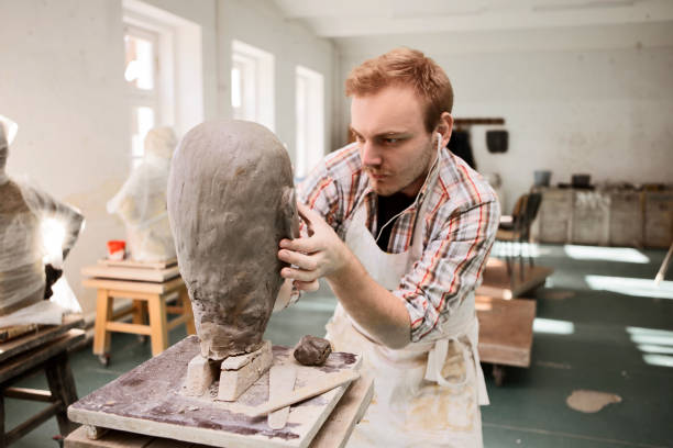 istock Master of sculpting working on his clay head sculpture 1209715076