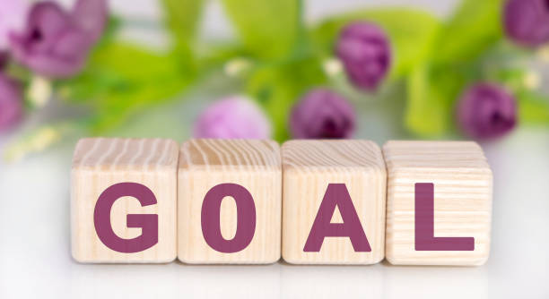 istock Goal concept on wooden cubes with floral background 1209715103