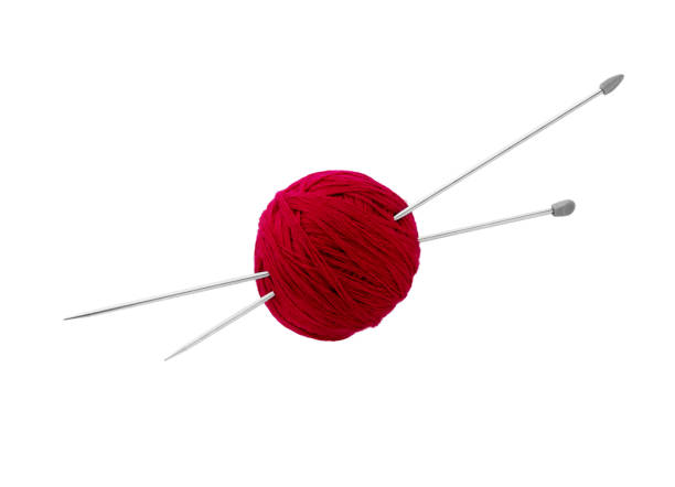 istock Balls of red wool yarn and knitting needles 1209715151