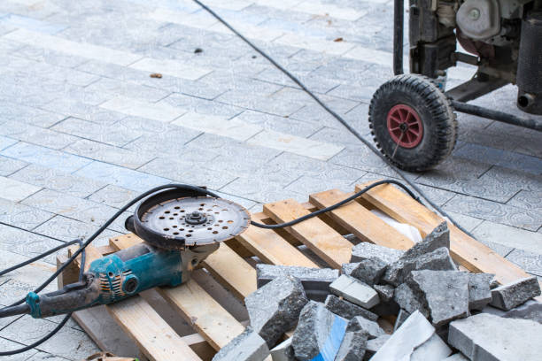 istock Construction work on pavement. Installation of concrete paver blocks on the sidewalk. Disc cutter lying on a wooden pallet. 1209715998