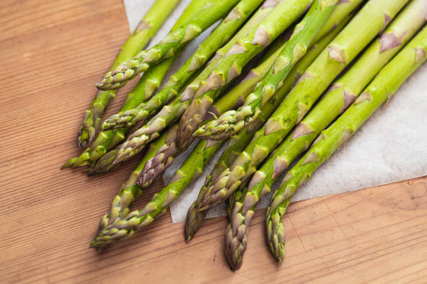 istock Fresh Raw Asparagus on a wooden background. 1209716359