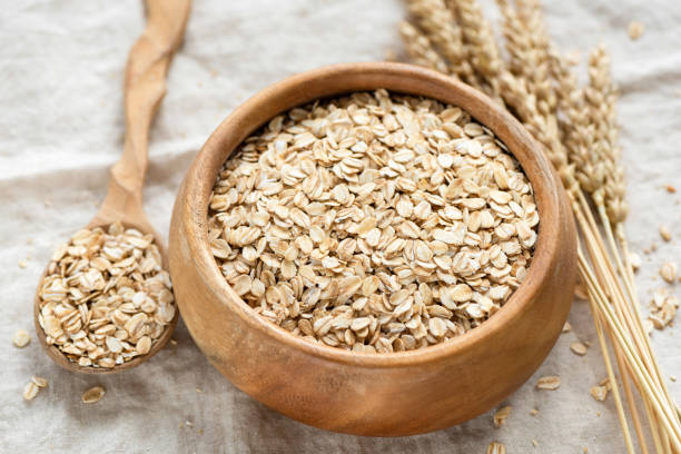 istock Oat flakes, rolled oats in wooden bowl 1209716442