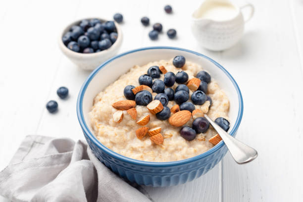 avena de desayuno saludable en tazón con arándanos y almendras - quinoa spoon wood photography fotografías e imágenes de stock