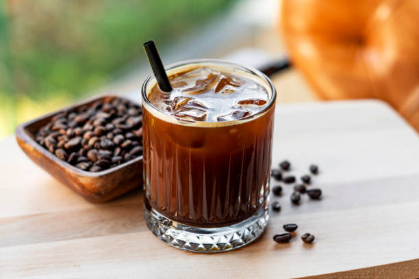 Cold brew coffee with milk and ice cubes in glass Cold brew coffee with milk and ice cubes in glass black coffee photos stock pictures, royalty-free photos & images