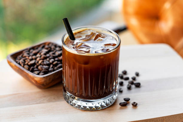 cold brew coffee with milk and ice cubes in glass - caramel latté coffee cafe macchiato imagens e fotografias de stock