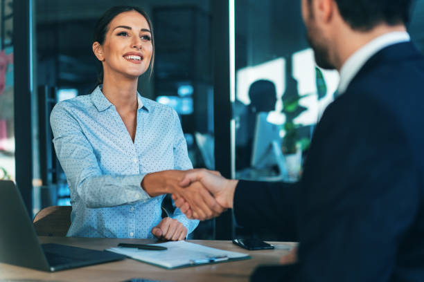 Business handshake Happy Smiling young business persons shaking hands after signing a contract recruiter photos stock pictures, royalty-free photos & images