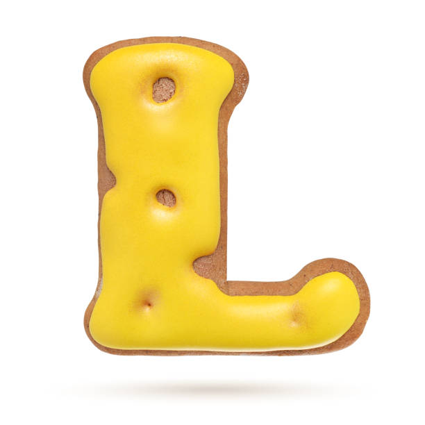 istock Capital letter L yellow gingerbread biscuit isolated on white. 1209723475