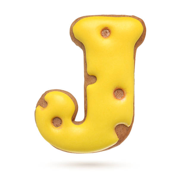 istock Capital letter J yellow gingerbread biscuit isolated on white. 1209723600