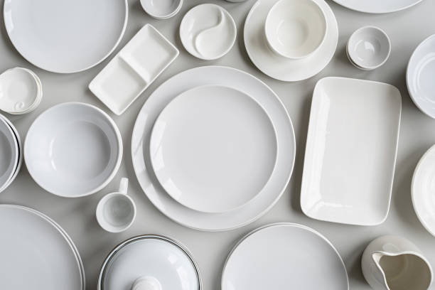 istock piles of white ceramic dishes and tableware top view on gray background 1209725289